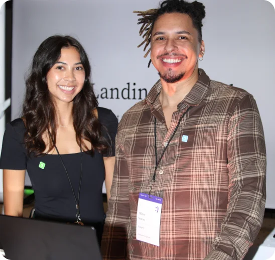 Two event hosts at a branded welcome booth